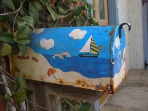 Rusty mailbox with sea scene